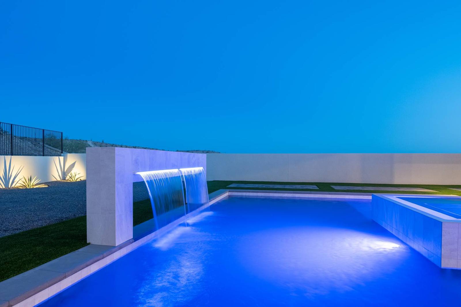 Twilight pool with raised spa and water feature at 6287 Avienda De Las Colinas