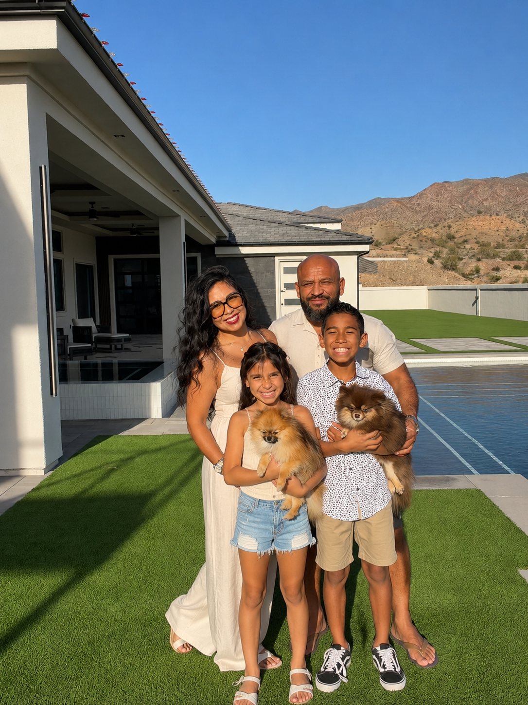 Jose and Jovian Moran with their son, daughter and two Pomeranians, poolside at home
